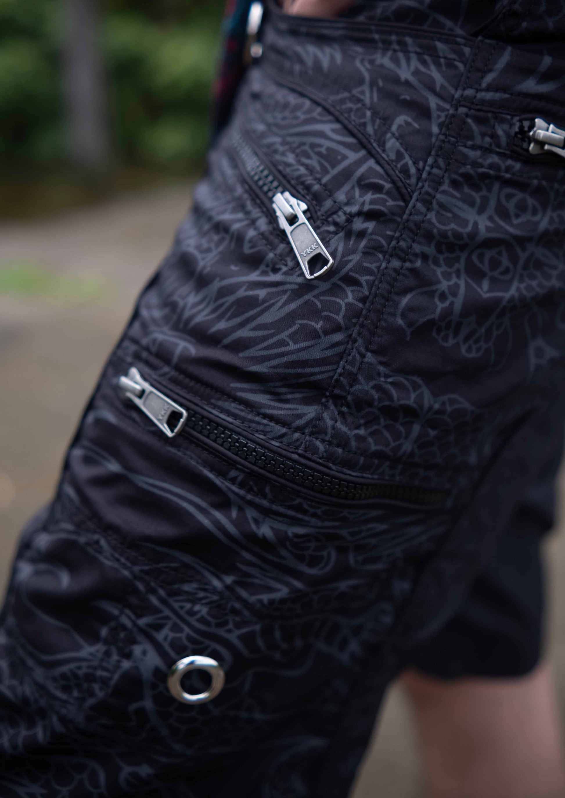 Black above knee men’s cargo shorts featuring multiple cargo pockets with durable YKK zippers
