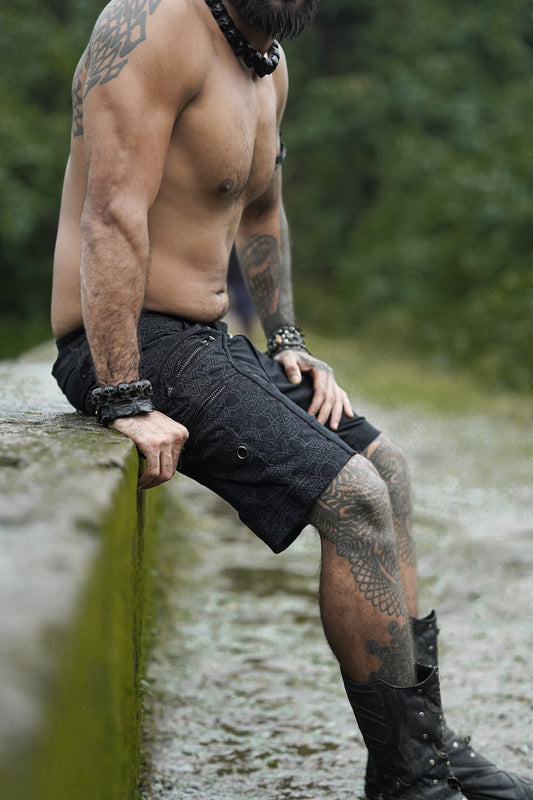 pythagoras jet black above the knee shorts men side sitting view
